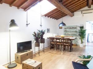 a living room with a table and a dining room at Lovely Apt 3min Walk to Ponte Vecchio in Florence