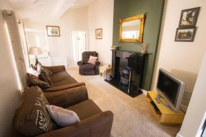 a living room with two couches and a television at Derry City Private Apartment in Culmore