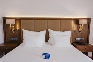 
A bed or beds in a room at Hotel Premium Chaves - Aquae Flaviae
