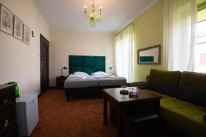 a living room with a bed and a couch at Dwór Ujazdowski in Nielisz