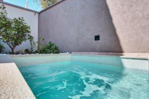 a swimming pool with blue water in a building at Casa Santa Maria Vacation House in Mali Lošinj