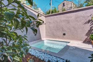 a swimming pool in the backyard of a house at Casa Santa Maria Vacation House in Mali Lošinj