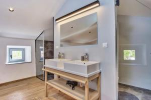 a bathroom with a white sink and a mirror at Casa Santa Maria Vacation House in Mali Lošinj