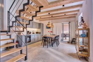 a kitchen and dining room with a spiral staircase at Casa Santa Maria Vacation House in Mali Lošinj