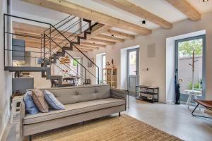 a living room with a couch and a staircase at Casa Santa Maria Vacation House in Mali Lošinj