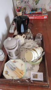 a tray with dishes and utensils on a table at Home from Home in Tersannes
