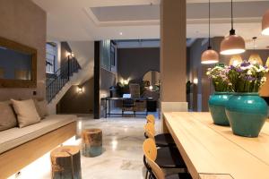 a living room with a vase of flowers on a table at Goodnight Cádiz Apartments in Cádiz