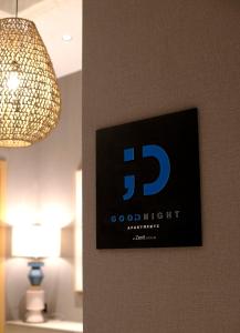 a sign on a wall next to a lamp at Goodnight Cádiz Apartments in Cádiz