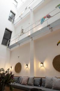 a living room with a couch and a ceiling at Goodnight Cádiz Apartments in Cádiz