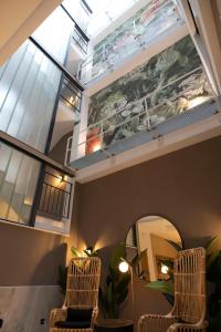 a room with two chairs and a mirror at Goodnight Cádiz Apartments in Cádiz