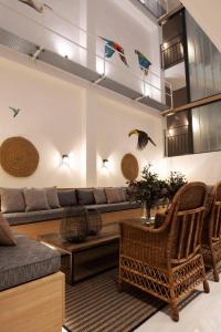 a living room with a couch and a table and chairs at Goodnight Cádiz Apartments in Cádiz