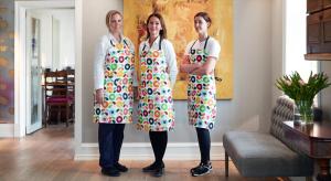 three women standing in a living room wearing aprons at Hotel Park Bergen in Bergen