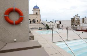 a swimming pool on the roof of a building at Goodnight Cádiz Apartments in Cádiz