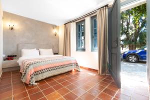 a bedroom with a bed and a large window at Hotel Pop Alaçatı in Alaçatı