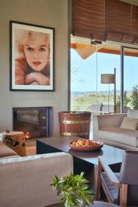 a living room with a couch and a fireplace at Empordà Golf Resort in Torroella de Montgrí