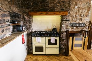 a kitchen with a stove and a stone wall at Our Holiday House Yorkshire, Ingleton - children and doggy friendly in Ingleton  +40 photos