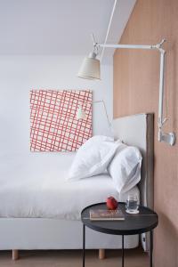 a bedroom with a bed with a table and a lamp at Empordà Golf Resort in Torroella de Montgrí