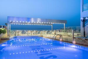 a swimming pool on the roof of a building at Denise Beach Hotel in Laganas