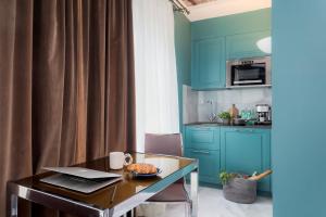a kitchen with blue cabinets and a table with food on it at VISIONAPARTMENTS Albertstrasse - self check-in in Zurich