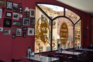 a restaurant with a bar and a clock on the wall at Hostal Quevedo in León