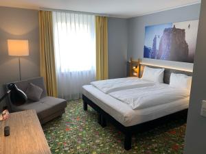 En eller flere senge i et værelse på Felix Hotel Kaufbeuren