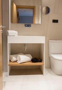 a bathroom with a sink and a toilet at Goodnight Cádiz Apartments in Cádiz