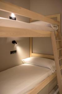 a couple of bunk beds in a small room at Goodnight Cádiz Apartments in Cádiz