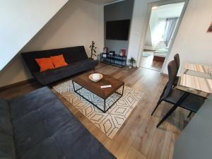 a living room with a couch and a table at Good times apartmán in Žilina