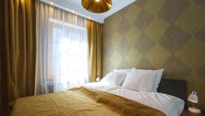 a bedroom with a large bed and a window at AntoniasLuxApart Free Parking in Rīga