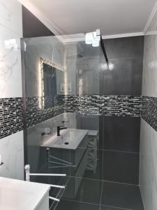 a bathroom with a sink and a mirror at White Stone in Sibiu +23 photos