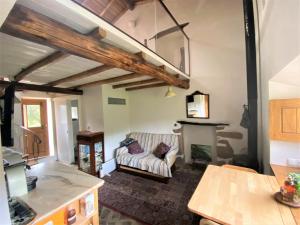 a living room with a couch and a fireplace at Monte das Cascatas in Marvão