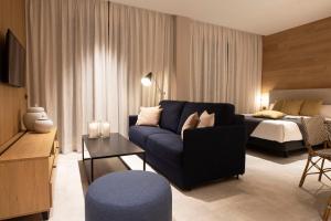 a living room with a couch and a bed at Goodnight Cádiz Apartments in Cádiz