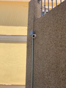 a security camera on the side of a building at Apartamento con jardín y piscina en el faro de calaburras in Mijas Costa +8 photos