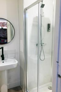 a bathroom with a shower and a sink at Beaverhall Apartments in Edinburgh