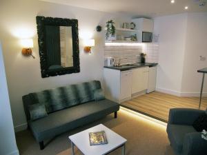 a living room with a couch and a kitchen at Beaverhall Holiday Apartments in Edinburgh +31 photos