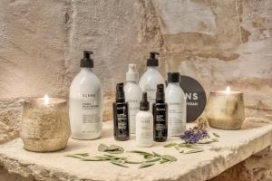 a group of bottles sitting on a table with candles at Can Alberti 1740 Boutique Hotel in Mahón