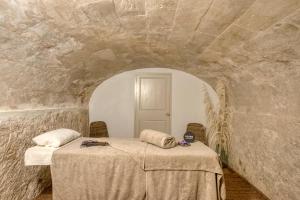 a room with a table in a stone wall at Can Alberti 1740 Boutique Hotel in Mahón