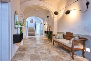 a hallway with a bench in a building at Can Alberti 1740 Boutique Hotel in Mahón