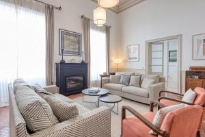 a living room with two couches and a fireplace at Can Alberti 1740 Boutique Hotel in Mahón