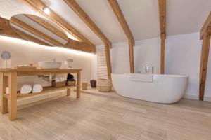 a large bathroom with a tub and a sink at Can Alberti 1740 Boutique Hotel in Mahón