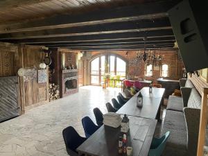 a room with tables and chairs and a fireplace at PUJSZANY AGROTURYSTYKA in Skierbieszów