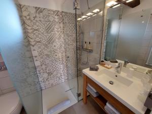 a bathroom with a shower and a sink and a toilet at Hôtel les Bouis - Vue mer in Saint-Tropez