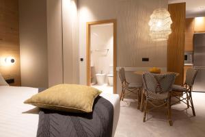 a bedroom with a bed and a table and chairs at Goodnight Cádiz Apartments in Cádiz