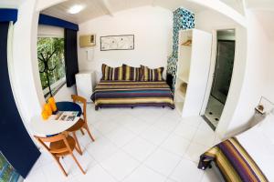 a living room with a couch and a table at Pousada Suarez in Penedo +189 photos