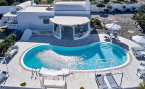 an overhead view of a pool with chairs and a house at La Maison Private Villa in Agia Paraskevi