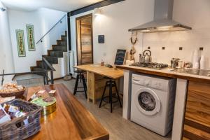 a kitchen with a washing machine in the middle at Morry's Lodge Guest House in Sora