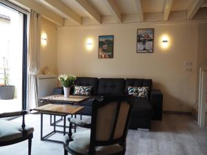 a living room with a couch and a table at La Meïzou de Bouly in Martres-de-Veyre