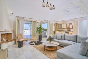 a living room with a couch and a table at La Maison Private Villa in Agia Paraskevi