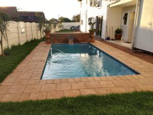 a small swimming pool in the yard of a house at Ecotel OR Tambo Airport in Kempton Park