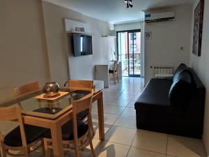 een woonkamer met een tafel en een bank bij Departamentos Illia By Lugar in Cordoba